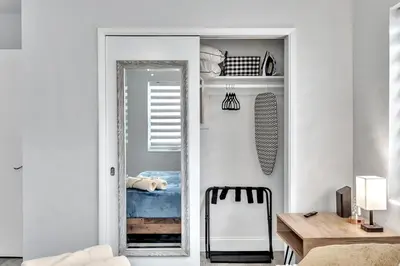a mirror in a room with a table and a chair at 3br Villa W Fire Pit By Hard Rock Hotel & Casino in Fort Lauderdale