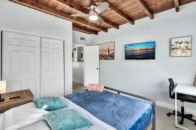 a bedroom with a bed and a desk and a ceiling at 3br Villa W Fire Pit By Hard Rock Hotel & Casino in Fort Lauderdale