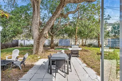a patio with a table and chairs in a yard at 3br Villa W Fire Pit By Hard Rock Hotel & Casino in Fort Lauderdale
