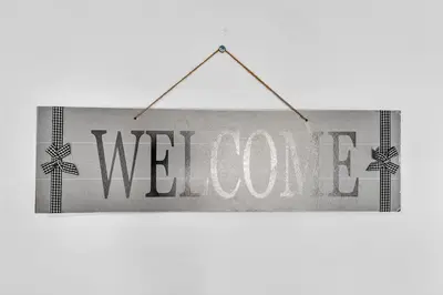 a sign with the word welcome hanging on a wall at Hollywood Blvd Near The Beach 