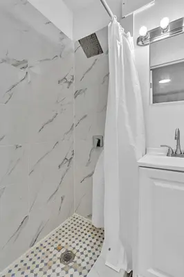 a white bathroom with a shower and a sink at Young Circle & Hollywood Blvd Posh Studio Suite in Hollywood