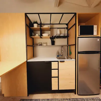 a small kitchen with a sink and a refrigerator at Private Home Studio Central Located in Miami 1 in Opa-locka