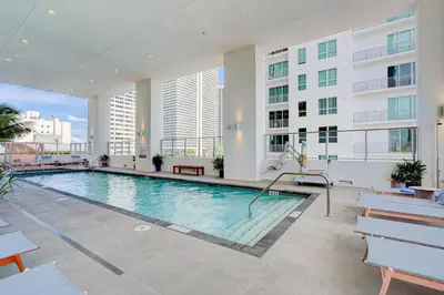 a large swimming pool in a building with buildings at 227-2500FU DOWNTOWN MIAMI 1 BEDROOM CONDO in Miami