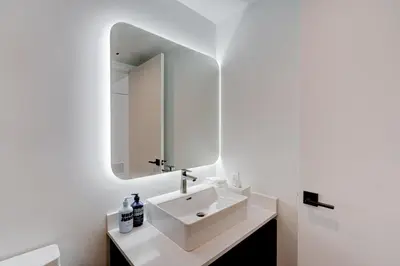 a bathroom with a white sink and a mirror at 1912AA DOWNTOWN MIAMI STUDIO in Miami
