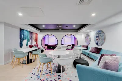 a waiting room with tables and chairs and mirrors at 1912AA DOWNTOWN MIAMI STUDIO in Miami