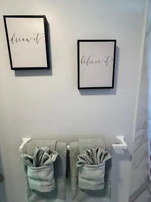 two framed pictures on a white wall with towels at Apartment in Hollywood close to shops & beach 110 in Hollywood