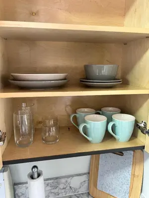 a wooden shelf with cups and plates on it at Apartment in Hollywood close to shops & beach 110 in Hollywood