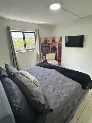 a bedroom with a large bed and a television at Apartment in Hollywood close to shops & beach 110 in Hollywood