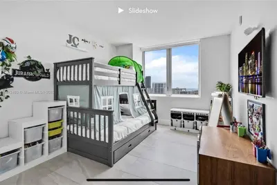 a bedroom with a bunk bed and a desk at Apartment 3B/3B Stunning view of the intercostal in Hallandale Beach