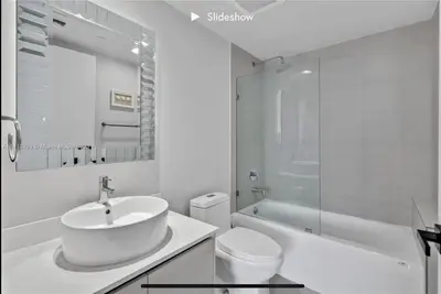 a white bathroom with a sink and a toilet at Apartment 3B/3B Stunning view of the intercostal in Hallandale Beach