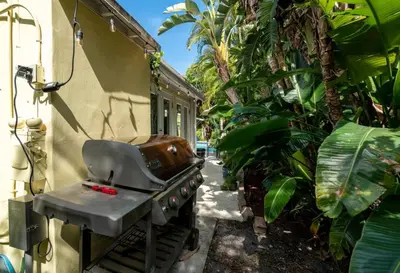 a grill outside of a house with plants at Charming Cottage 1BR, Pool, Victoria Park in Fort Lauderdale