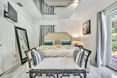a bedroom with a large bed with blue pillows at Family Home 2BR Heated Pool, Victoria Park in Fort Lauderdale