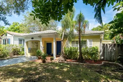 a house with palm trees in front of it at Family Home 2BR Heated Pool, Victoria Park in Fort Lauderdale
