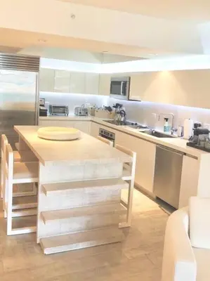 a kitchen with a wooden counter top in a room at Oceanview 1 Hotel & Homes 1 Bedroom 1 and Half Bathrooms Luxe Condo with Balcony in Miami Beach