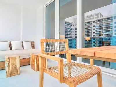 a living room with a bench and a table at Oceanview 1 Hotel & Homes 1 Bedroom 1 and Half Bathrooms Luxe Condo with Balcony in Miami Beach