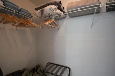 a walk in closet with a shelf and some shoes at Lovely Midblock building 1 bedroom 1 bathroom apartment in Miami