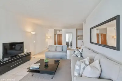 a living room with a couch and a tv at Tides building over the beach apartments in Hollywood