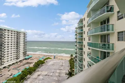 a view of the beach from the balcony of a building at Tides building over the beach apartments in Hollywood