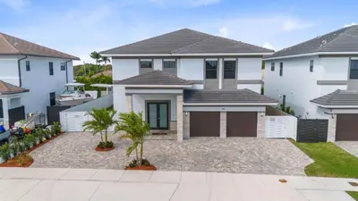 a large white house with a driveway at Miami Oasis Villa, Your Luxury Haven in Tamiami