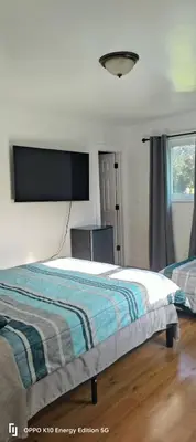 a bedroom with a bed and a flat screen tv at Edercozy in Miami