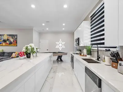 a kitchen with white counter tops and a table at Villa ART Pool Golf Volleyball in Miami