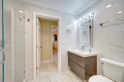 a white bathroom with a sink and a shower at Tropical Oasis 6BR & 4BR Villa Heated Pool & Billiard Room in Hollywood