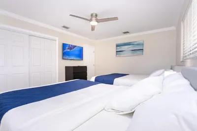 two beds in a bedroom with white walls at Amazing 5BR Villa Heated Pool near Hard Rock in Hollywood