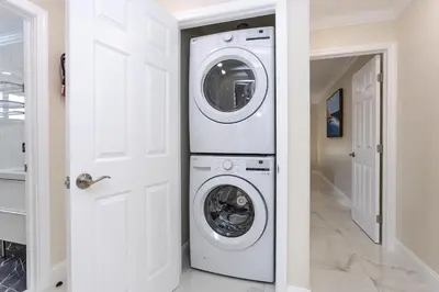 a white washer and dryer in a white hallway at Amazing 5BR Villa Heated Pool near Hard Rock in Hollywood