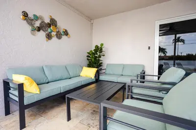 a living room with two blue couches and a table at Amazing 5BR Villa Heated Pool near Hard Rock in Hollywood