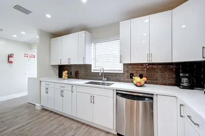 a kitchen with white cabinets and a dishwasher at Luxury Villa WALK 5 minutes to Hollywood Beach in Hollywood