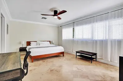 a bedroom with a bed and a ceiling fan at Magnificent Villa by Lake near Hollywood Beach in Hollywood