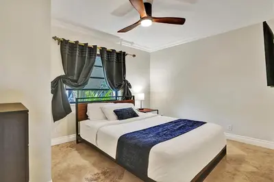 a bedroom with a bed and a ceiling fan at Magnificent Villa by Lake near Hollywood Beach in Hollywood