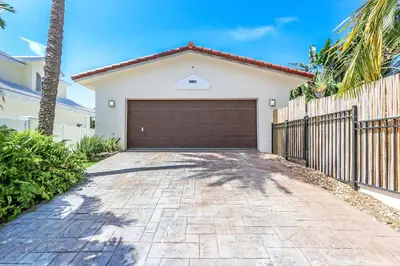 a garage in a house with a fence at Magnificent Villa by Lake near Hollywood Beach in Hollywood