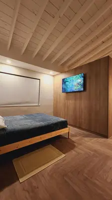 a bedroom with a bed and a tv on a wall at Private Home Studio Central Located in Miami 2 in Opa-locka