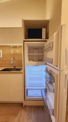 an empty refrigerator with its door open in a kitchen at Private Home Studio Central Located in Miami 2 in Opa-locka