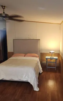a bedroom with a large bed and a table at 1233 Apartment 1 Miami in Tamiami