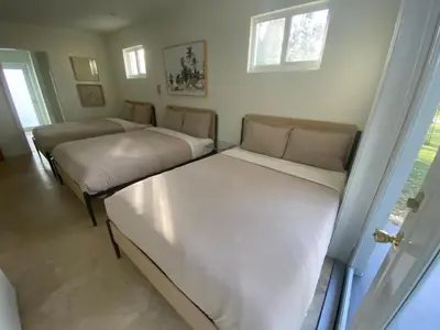 a room with two beds and a couch at Entire home in Biscayne Park, Florida in Biscayne Park