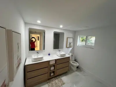 a bathroom with two sinks and a toilet at Entire home in Biscayne Park, Florida in Biscayne Park