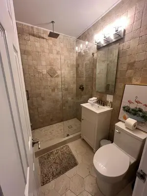 a bathroom with a shower and a toilet and a sink at Entire home in Biscayne Park, Florida in Biscayne Park