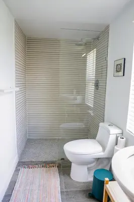 a bathroom with a toilet and a glass shower at New Nordic Touch Loft, Central Location in Miami