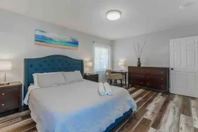 a bedroom with a bed with white shoes on it at Charming house Miami in Miami