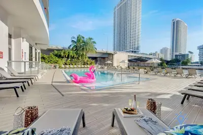 a pool with a pink flamingo in the middle of a building at Spectacular Apartment Beachwalk Bliss Pool Gym in Hallandale Beach