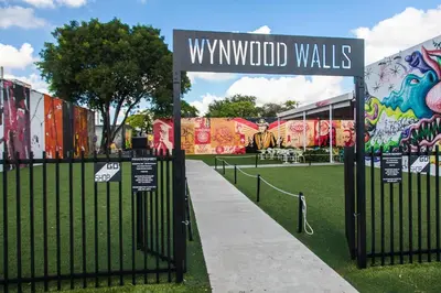 a fence with a sign that reads wynwood walls at Suite Azul Miami - Private Guest Suite with Patio, Free Parking, Near Wynwood and Beaches in Miami
