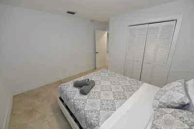 a bedroom with a bed with a pair of shoes on it at N61 in Hollywood