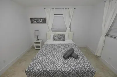 a bedroom with a bed with a black and white comforter at N61 in Hollywood