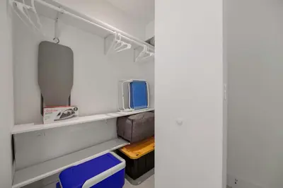 a closet with white walls and white shelves at Condo with Amazing Views in the Heart of Brickell in Miami