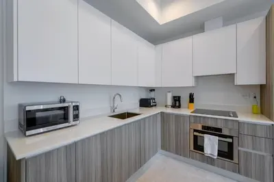 a kitchen with white cabinets and a microwave at Condo with Amazing Views in the Heart of Brickell in Miami