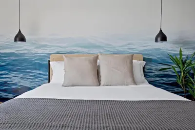 a bedroom with a bed with a painting of the ocean at Bayshore Bliss, Cozy with Water Views of Miami Bay in Miami Beach