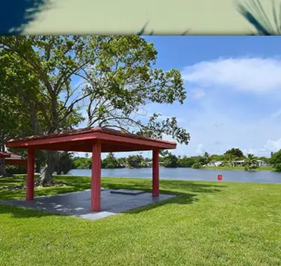 a red pavilion in the grass next to a lake at 1233 Apartment 2 Miami in Tamiami
