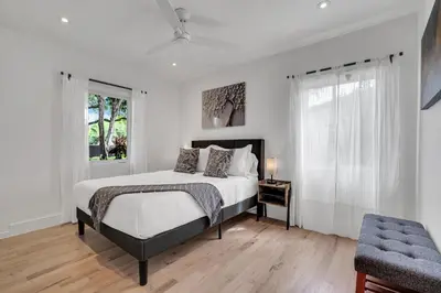 a white bedroom with a bed and a window at Samadhi - NEW 15 min drive to Ultra, by Newman Hospitality in Miami Shores
